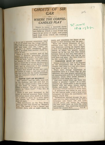 Image of newspaper clippings stuck onto a page.