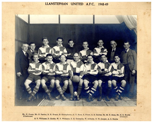 Black and white photograph of a group of men in football attire.