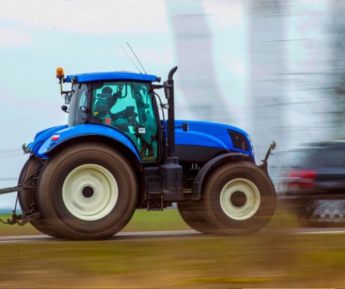 Blue Tractor on the highway