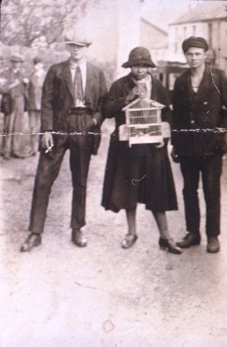The second image shows a mixed-race woman seemingly holding a birdcage with a young white male flanking her either side.