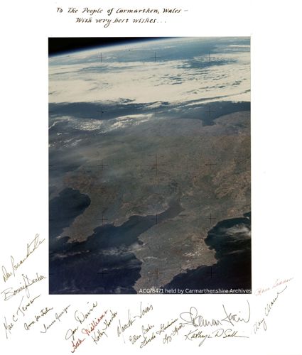 Satellite photograph of the earth from space with signatures encircling the image.
