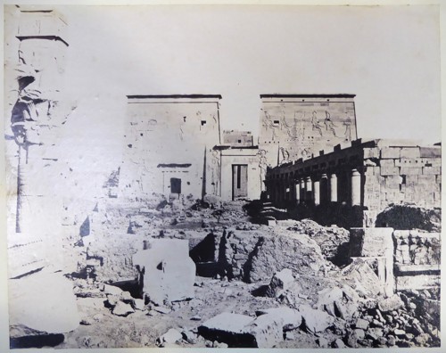 Old black and white photograph of the foreground of an ancient Egyptian temple seemingly in ruin.