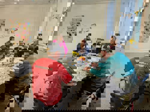 Group of people around a table at Carmarthen warm hub